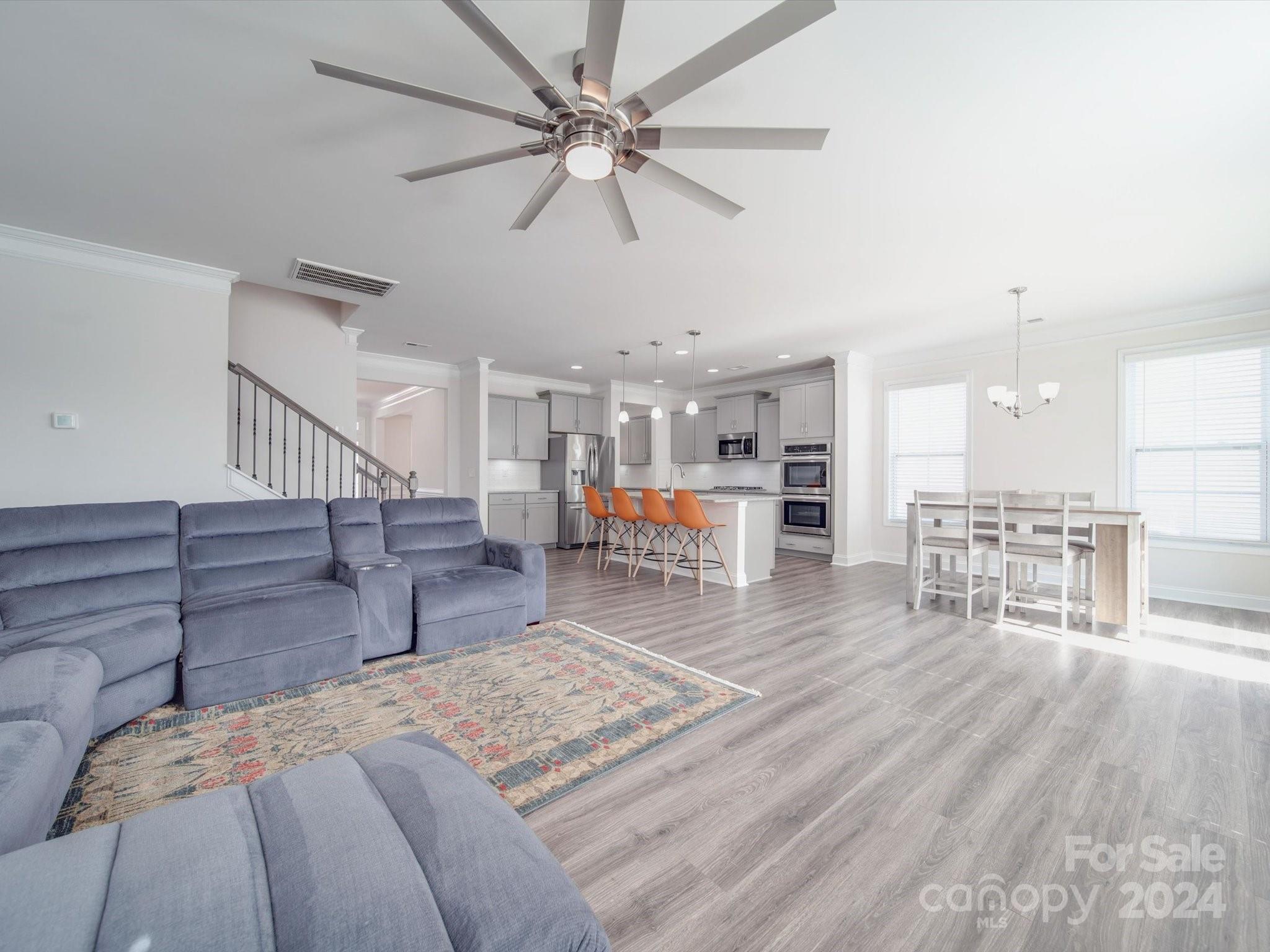 5901 Redwood Pine Road Concord, NC 28027 - Photo 9 of 39 a living room with furniture and kitchen view with wooden floor