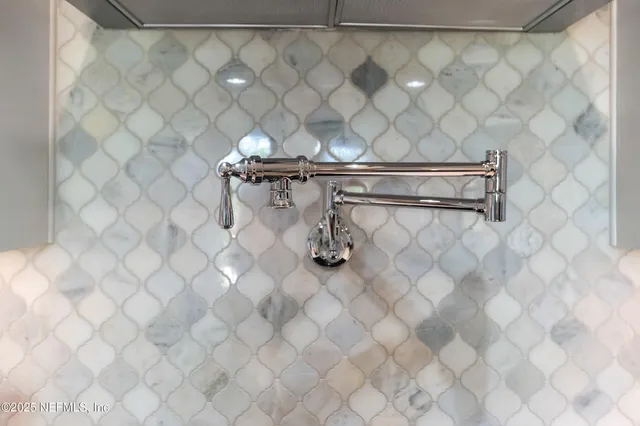 a living room with lots of furniture and view of kitchen