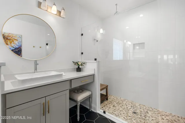 a bathroom with a sink a toilet and shower