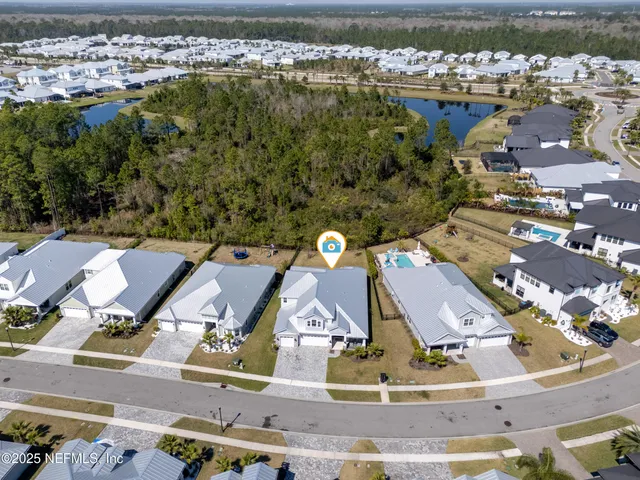 an aerial view of residential houses with outdoor space