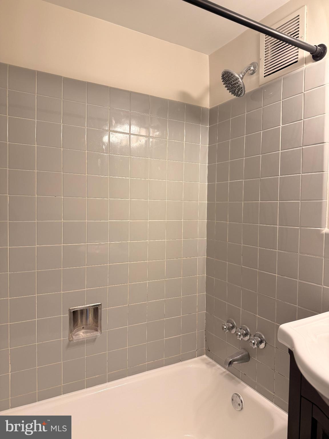 4740 Connecticut Avenue Northwest, Unit 112 Washington, DC 20008 - Photo 6 of 20 Sleek, modern bathroom with elegant tiles.