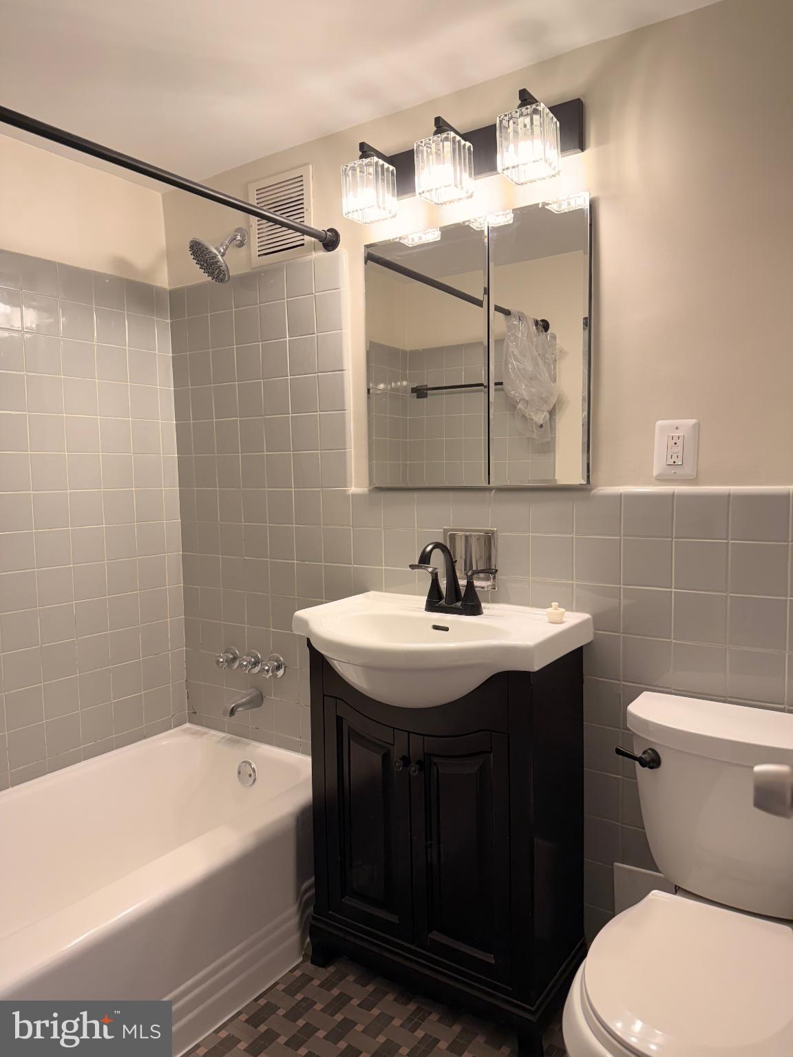 4740 Connecticut Avenue Northwest, Unit 112 Washington, DC 20008 - Photo 7 of 20 Modern elegance in a cozy bathroom retreat.