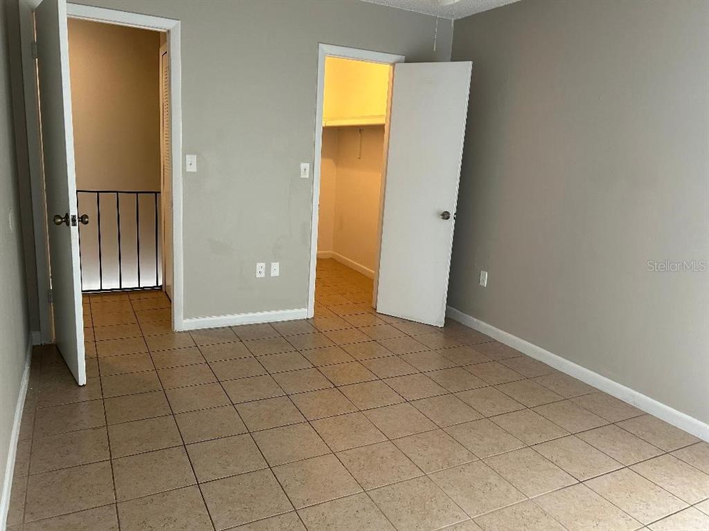 5582 Green Shadows Place, Unit 202 Orlando, FL 32811 - Photo 12 of 19 an empty room with windows and entrance