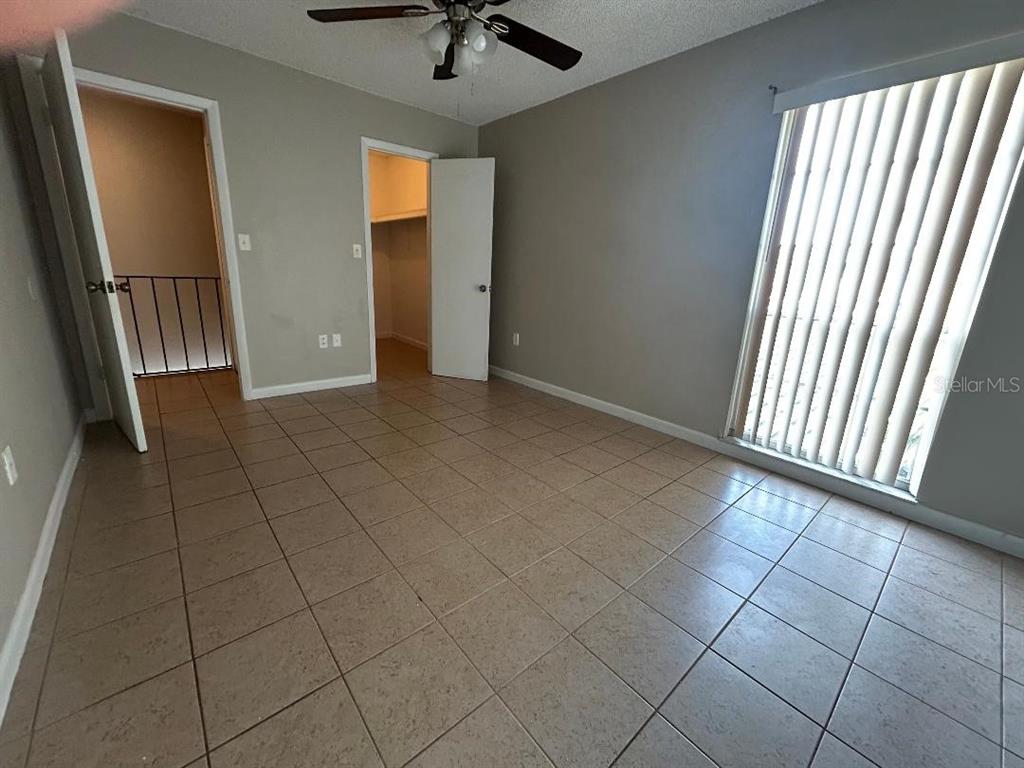5582 Green Shadows Place, Unit 202 Orlando, FL 32811 - Photo 13 of 19 an empty room with windows