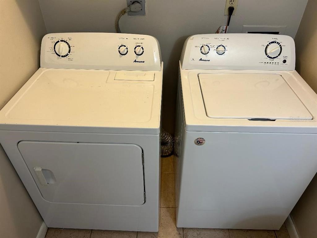 5582 Green Shadows Place, Unit 202 Orlando, FL 32811 - Photo 15 of 19 a utility room with dryer and washer