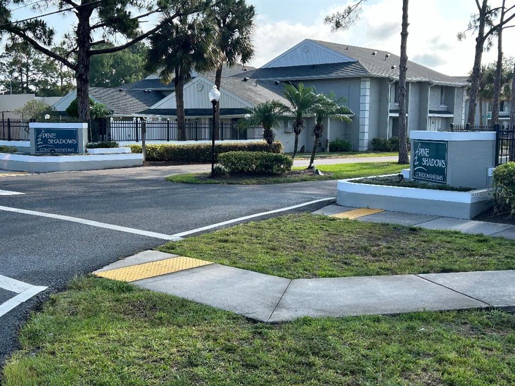 5582 Green Shadows Place, Unit 202 Orlando, FL 32811 - Photo 19 of 19 a front view of a house with a yard
