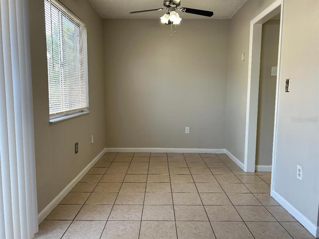 5582 Green Shadows Place, Unit 202 Orlando, FL 32811 - Photo 7 of 19 a view of an empty room with a window