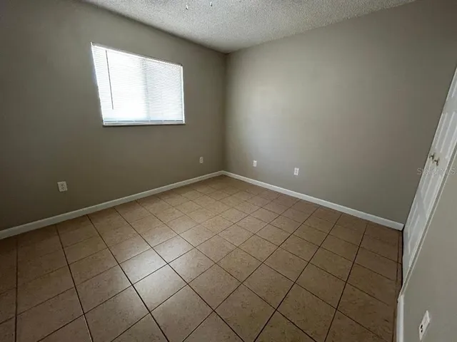 a view of an empty room and a window