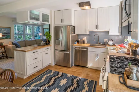 a kitchen with stainless steel appliances a stove refrigerator sink and cabinets