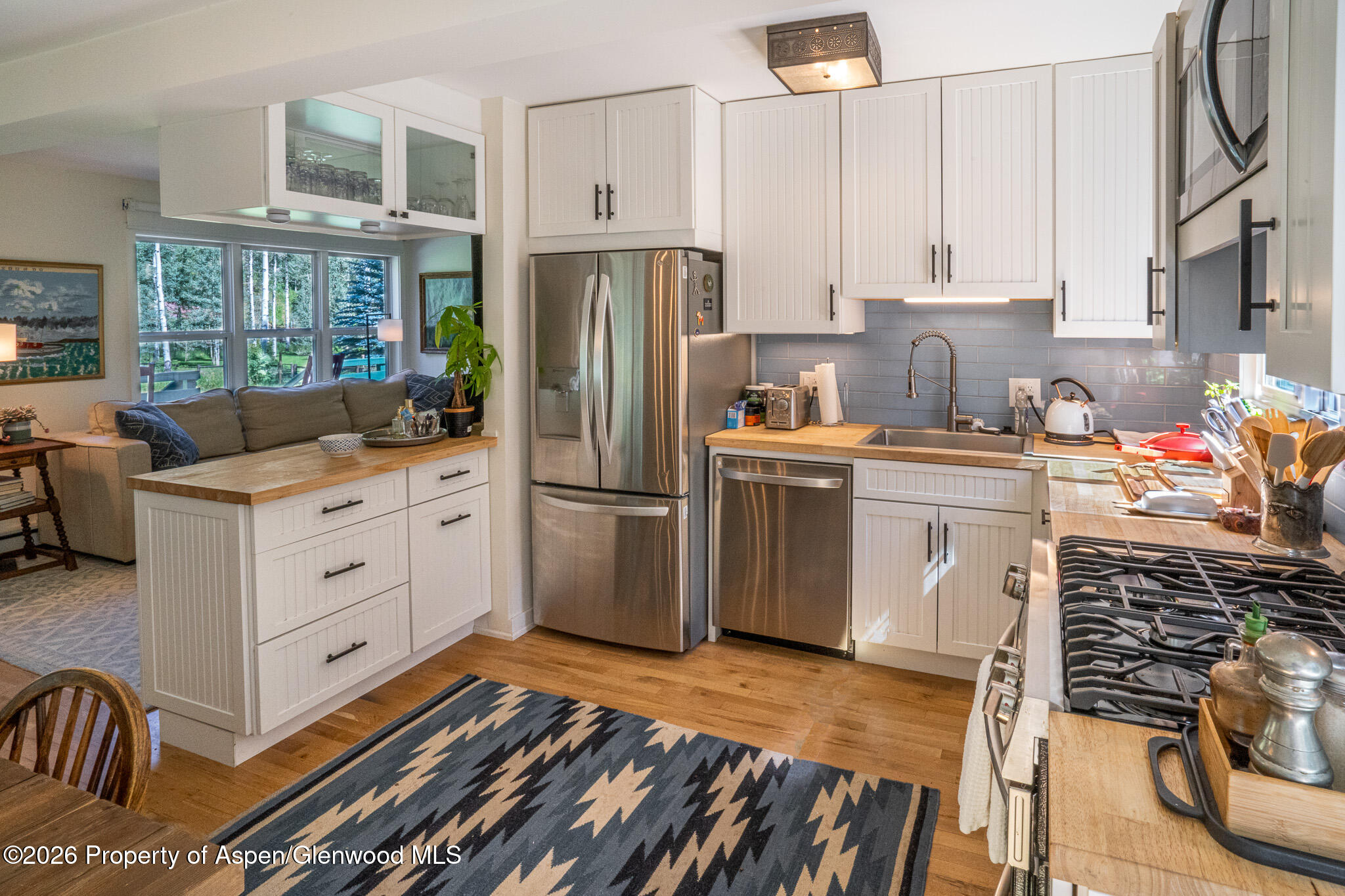285 Conundrum Creek Road Aspen, CO 81611 - Photo 16 of 35 a kitchen with stainless steel appliances a stove refrigerator sink and cabinets