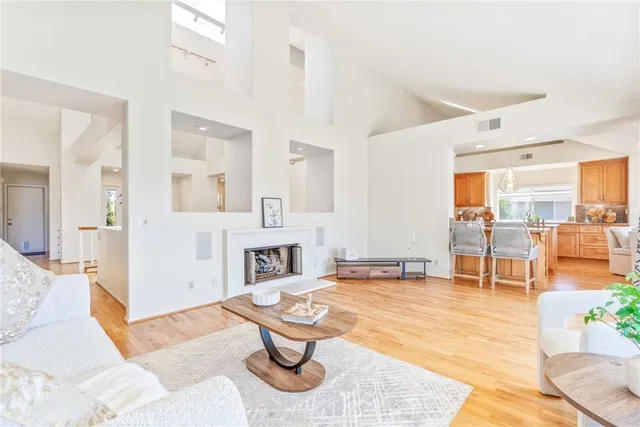 a kitchen with stainless steel appliances kitchen island granite countertop a table and chairs in it