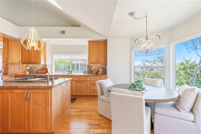 a living room with furniture a large window and wooden floor