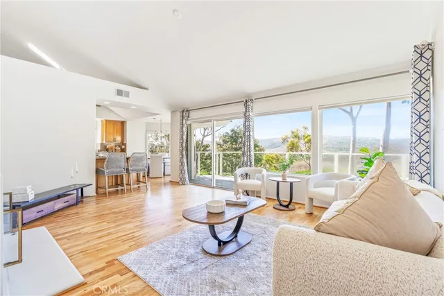 a front view of a house with yard and trees