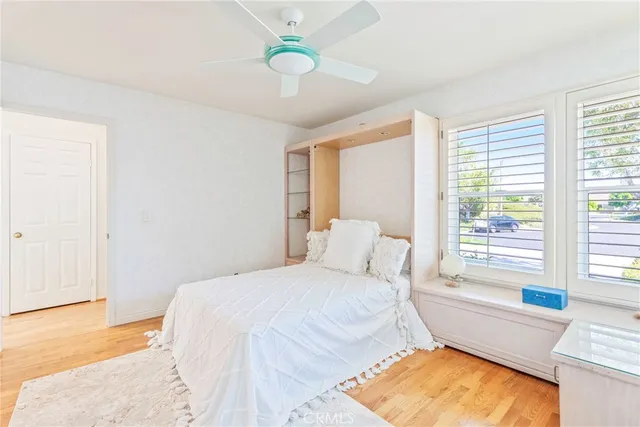 a bedroom with a bed and a painting on the wall