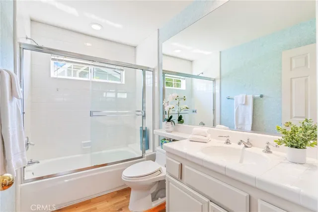 a spacious bedroom with a large bed and a chandelier