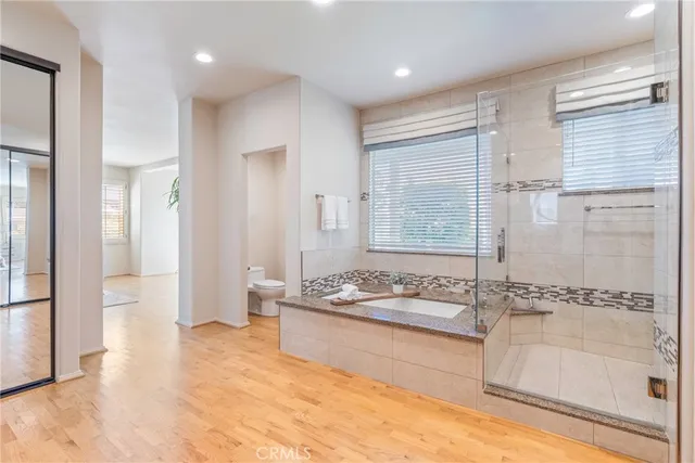 a bathroom with a granite countertop sink and mirror