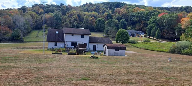 an aerial view of a house with a yard and sitting area