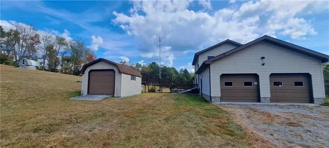 a view of a house with a yard and garage