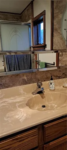 a bathroom with a sink and a mirror