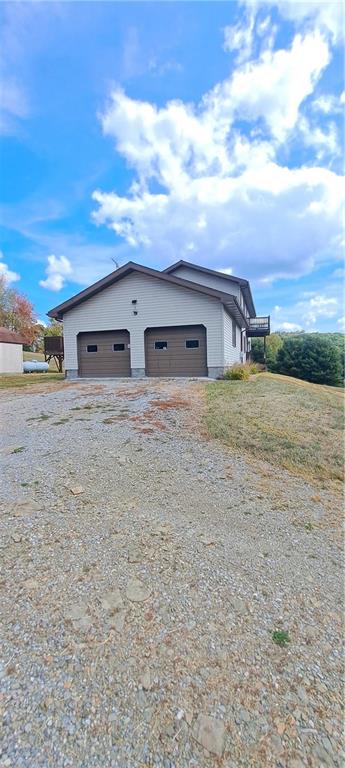 1825 Robertsville Road Punxsutawney, PA 15767 - Photo 9 of 22 a big white house with a big yard and large trees