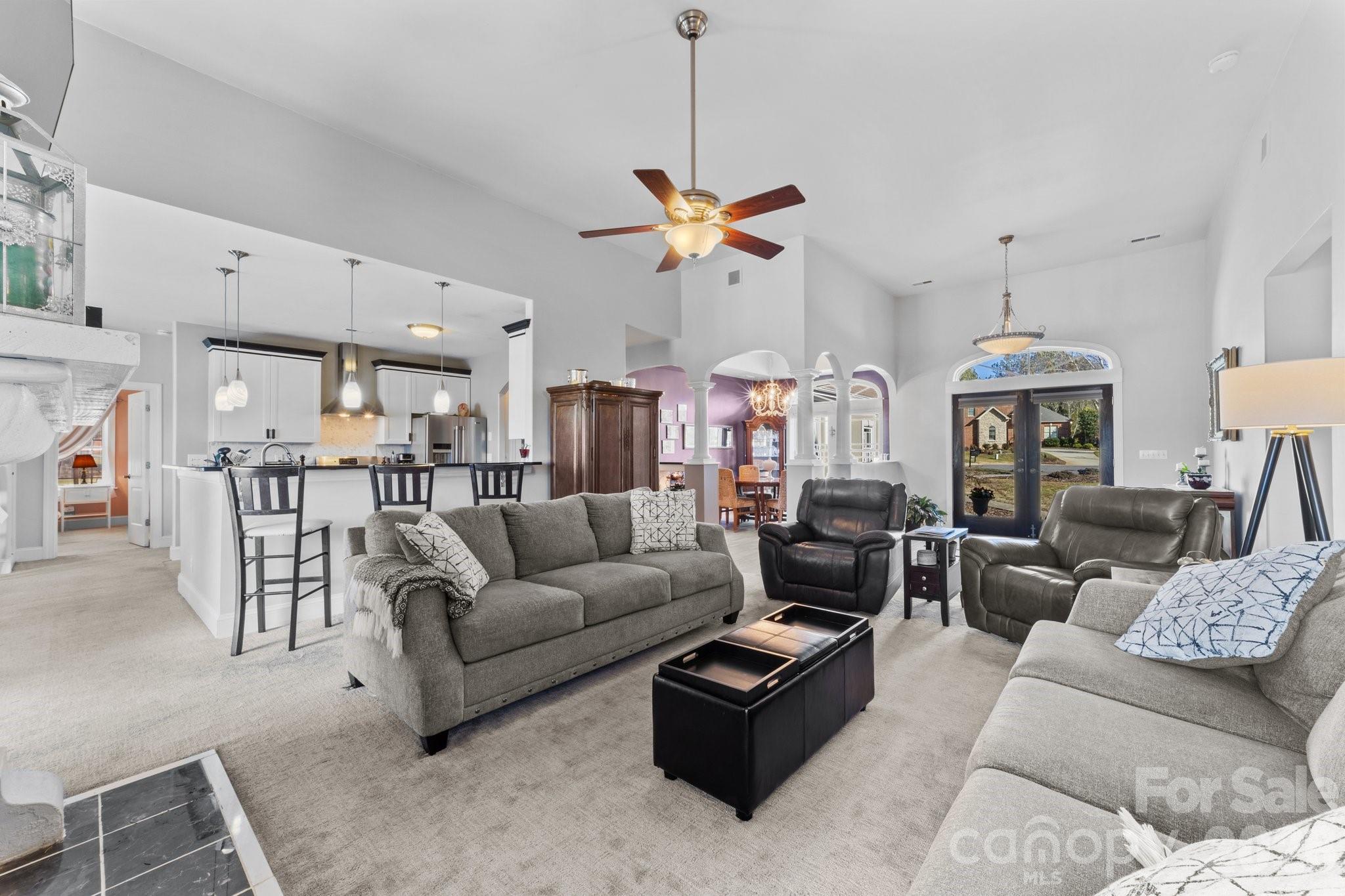 543 Muirfield Way Salisbury, NC 28144 - Photo 11 of 42 a living room with furniture kitchen view and a chandelier