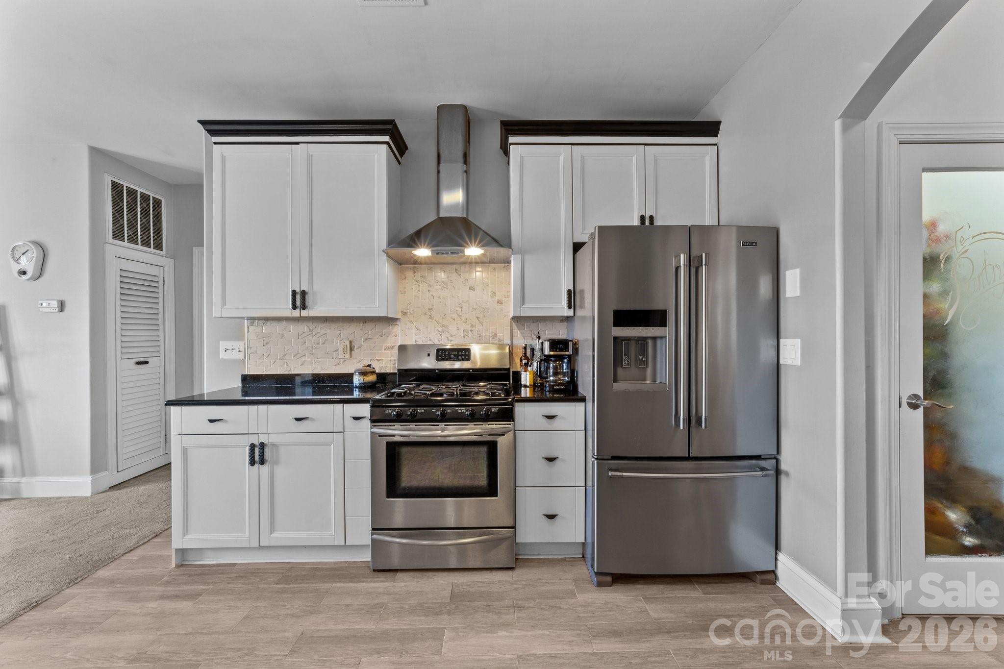 543 Muirfield Way Salisbury, NC 28144 - Photo 16 of 42 a kitchen with stainless steel appliances a refrigerator stove and microwave