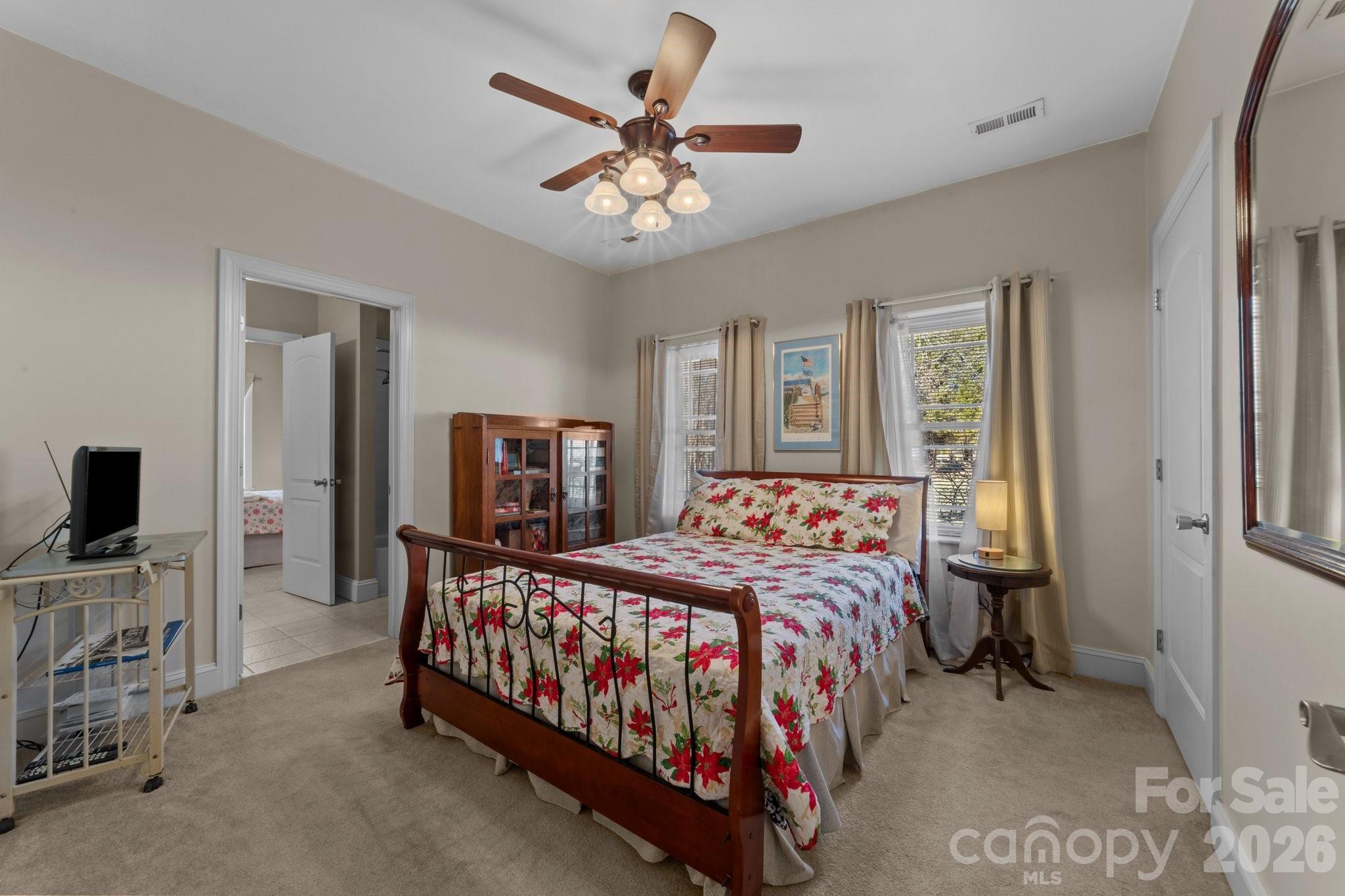 543 Muirfield Way Salisbury, NC 28144 - Photo 19 of 42 a bedroom with a bed and a chandelier