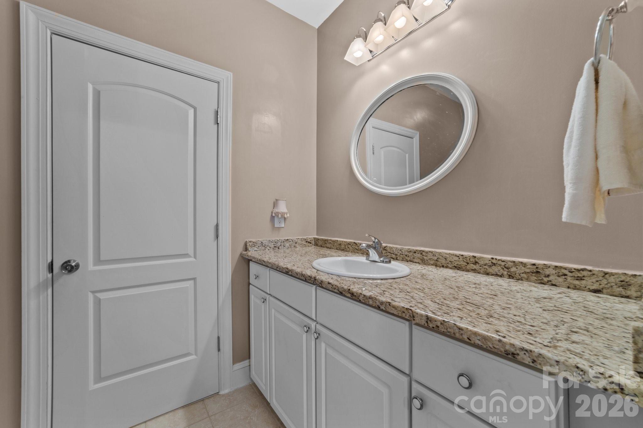 543 Muirfield Way Salisbury, NC 28144 - Photo 21 of 42 a bathroom with a granite countertop sink and a mirror