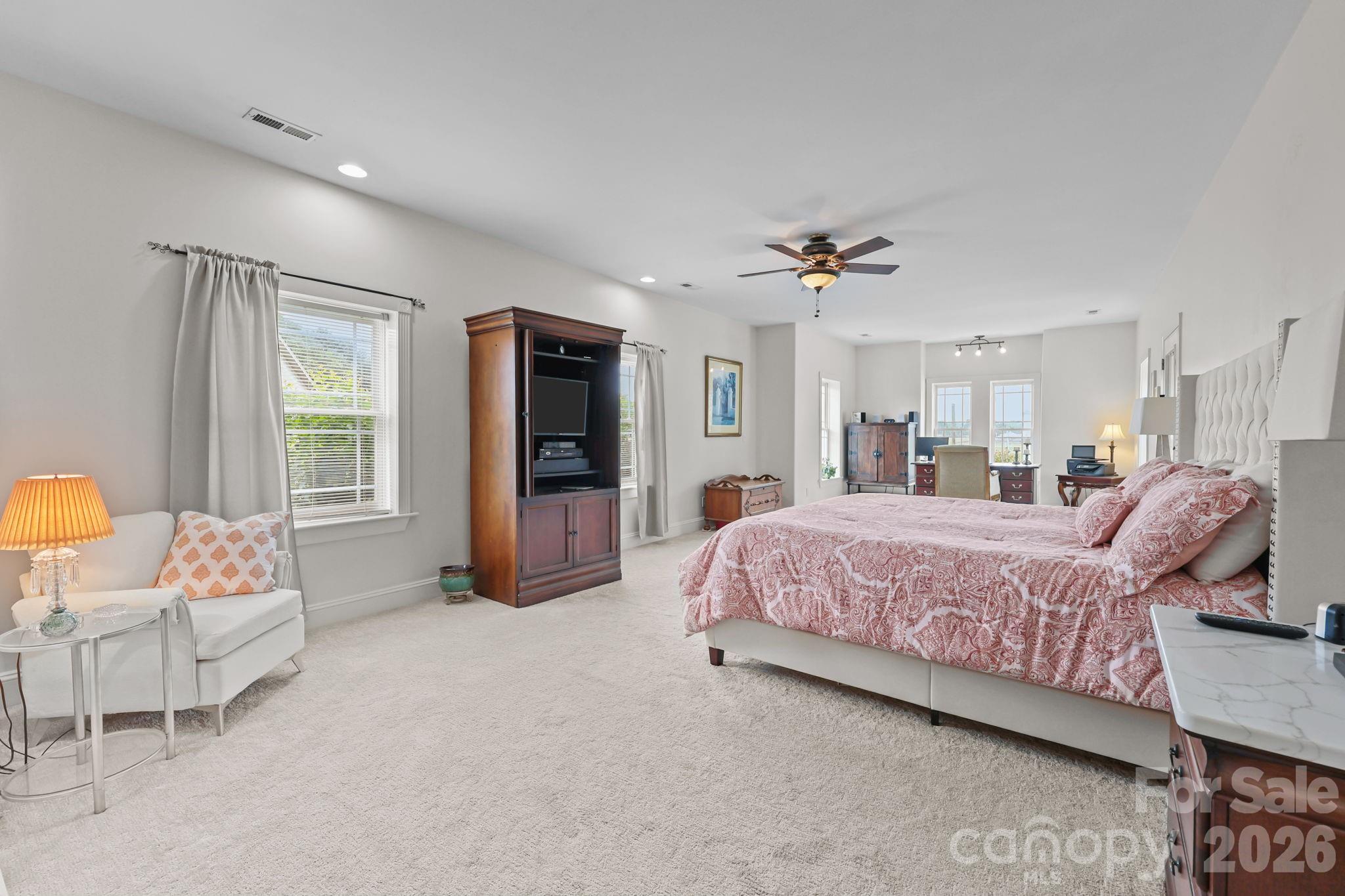 543 Muirfield Way Salisbury, NC 28144 - Photo 24 of 42 a spacious bedroom with a bed a couch and a window