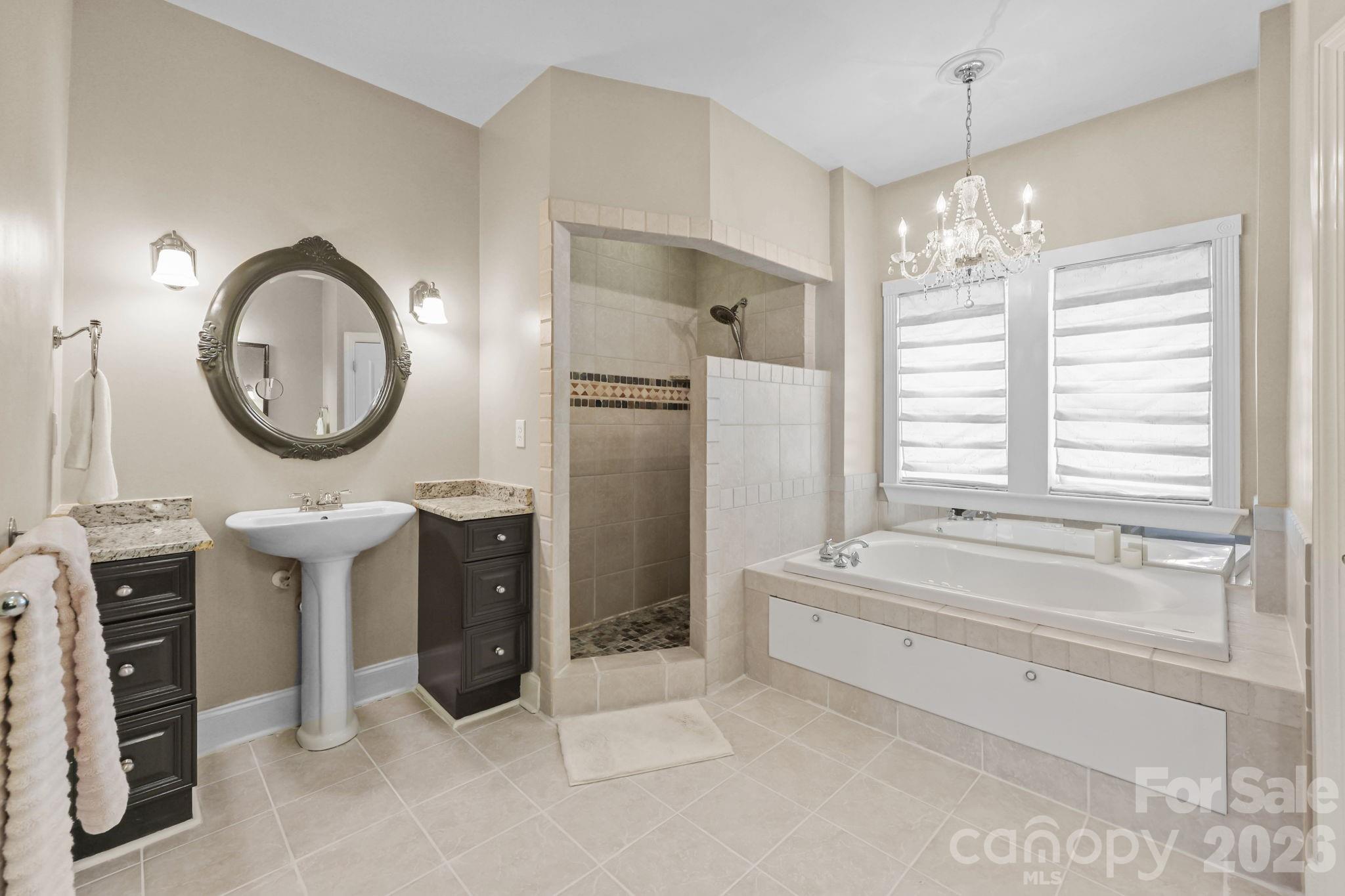 543 Muirfield Way Salisbury, NC 28144 - Photo 27 of 42 a spacious bathroom with a double vanity sink a mirror and a bathtub