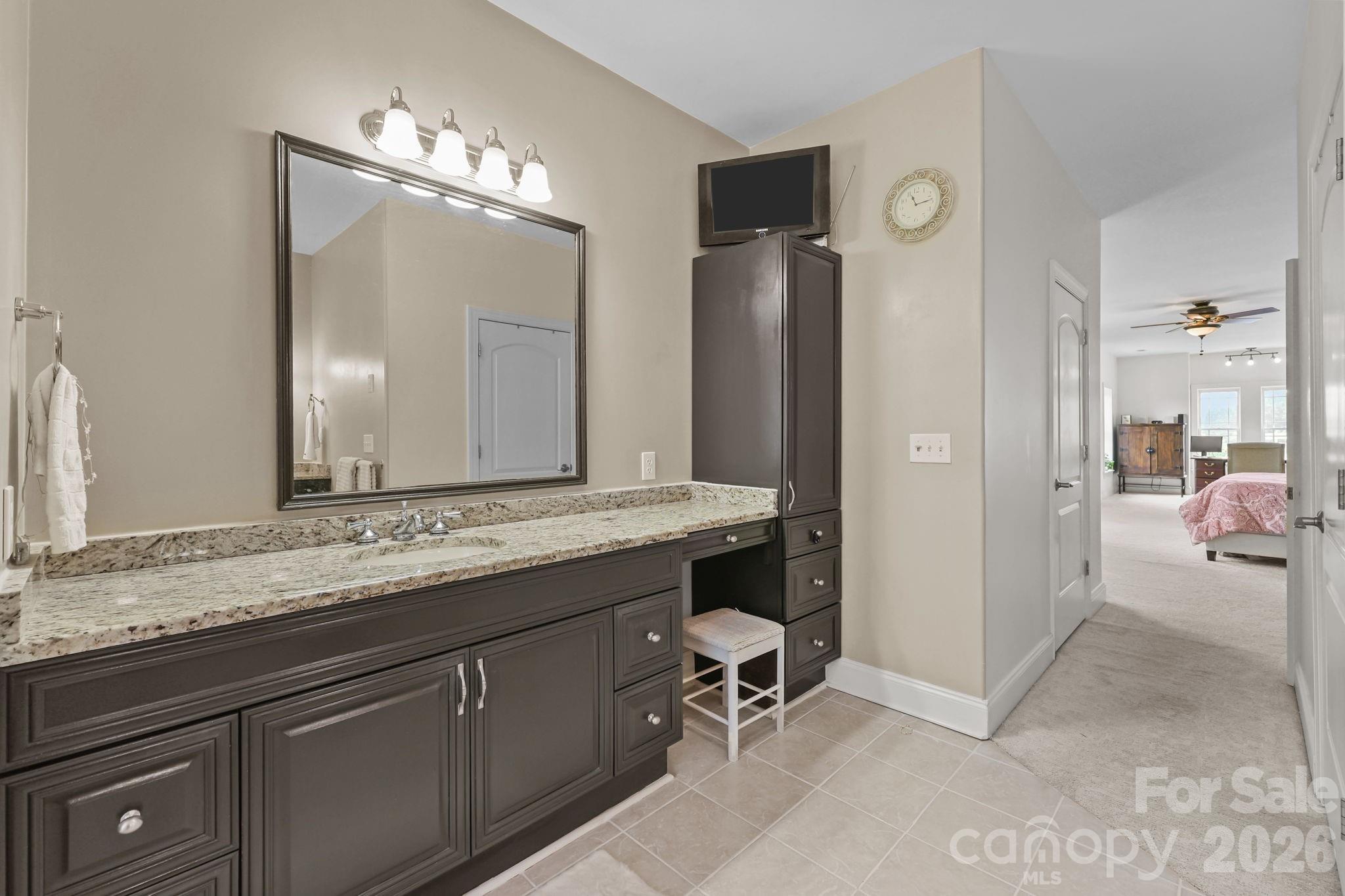 543 Muirfield Way Salisbury, NC 28144 - Photo 28 of 42 a en suite bathroom with a granite countertop sink and a mirror