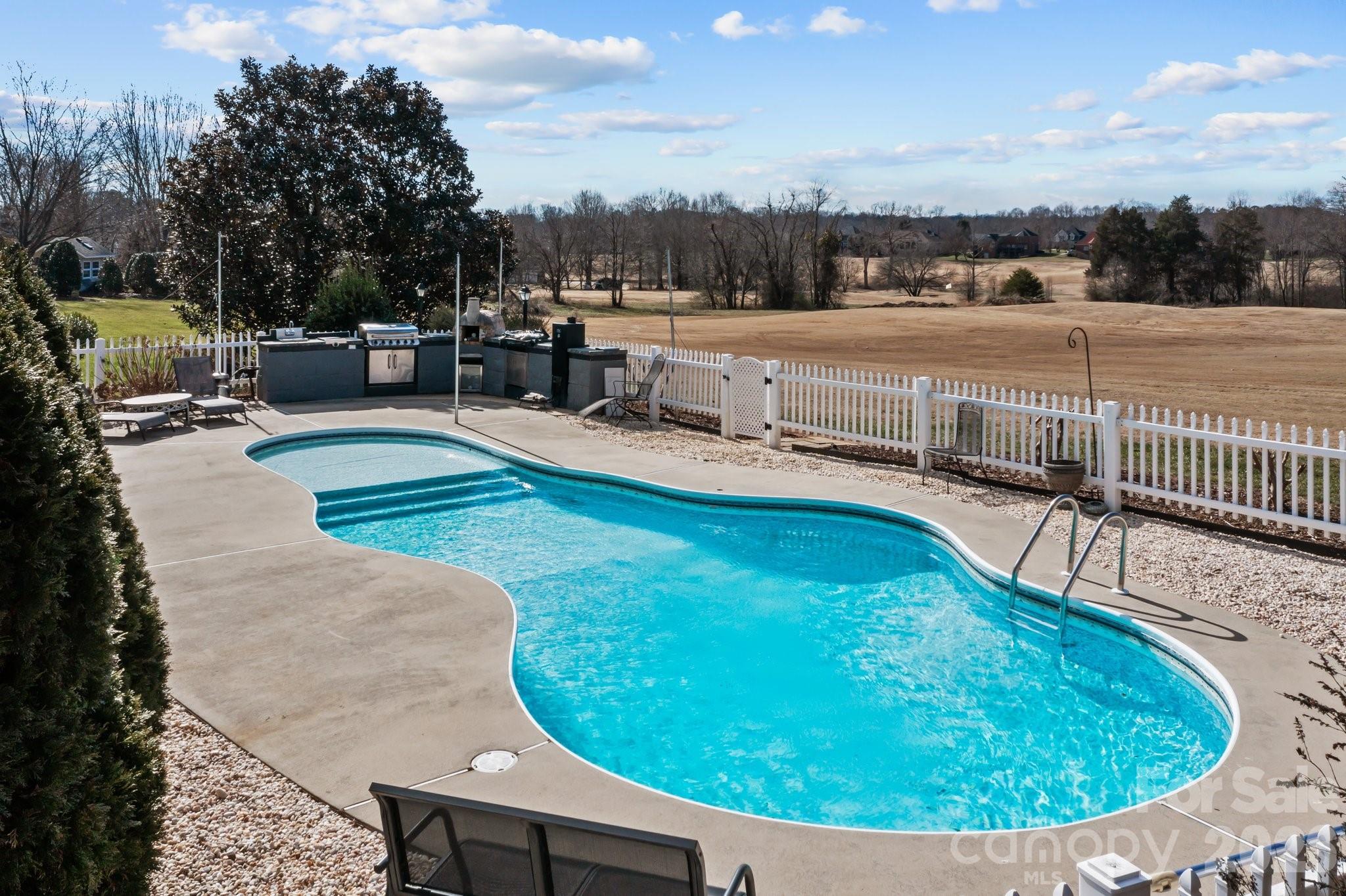543 Muirfield Way Salisbury, NC 28144 - Photo 38 of 42 a view of a swimming pool with a lounge chair