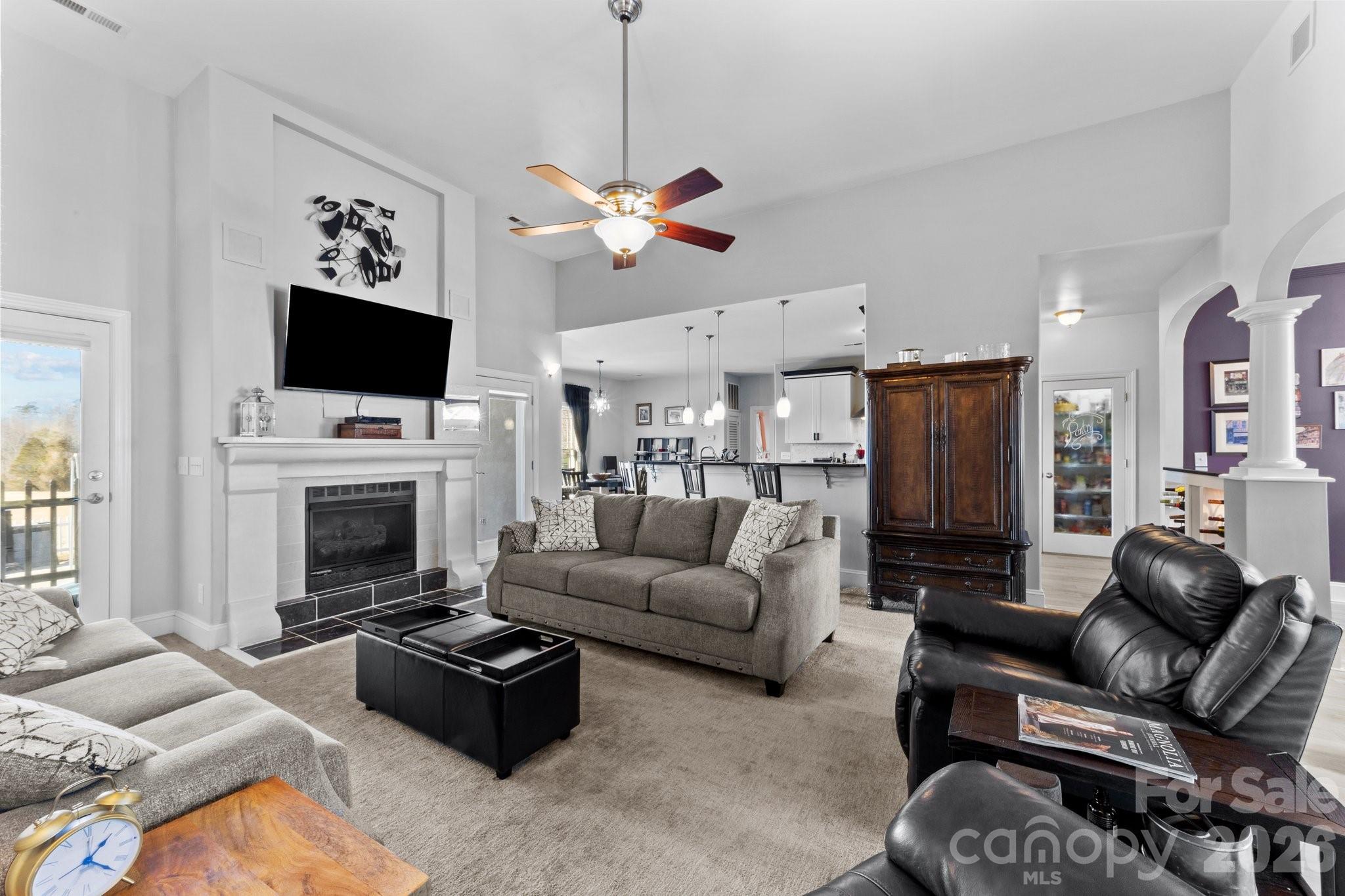 543 Muirfield Way Salisbury, NC 28144 - Photo 10 of 42 a living room with furniture a flat screen tv and a fireplace