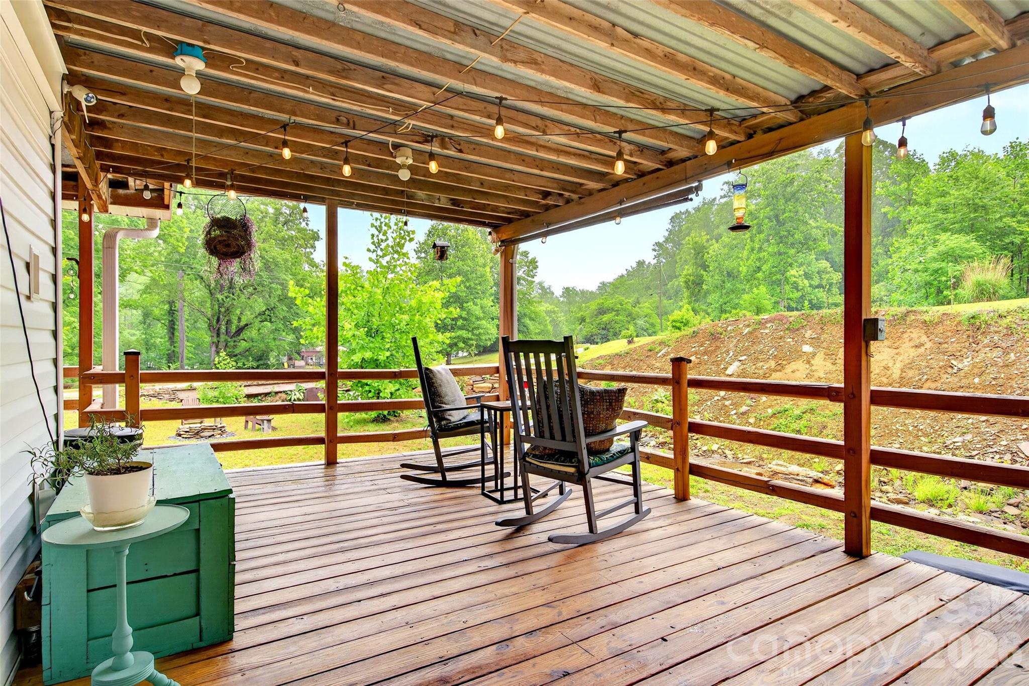 227 Locust Cove Road Marion, NC 28752 - Photo 12 of 34 a view of a deck with wooden floor and outdoor seating
