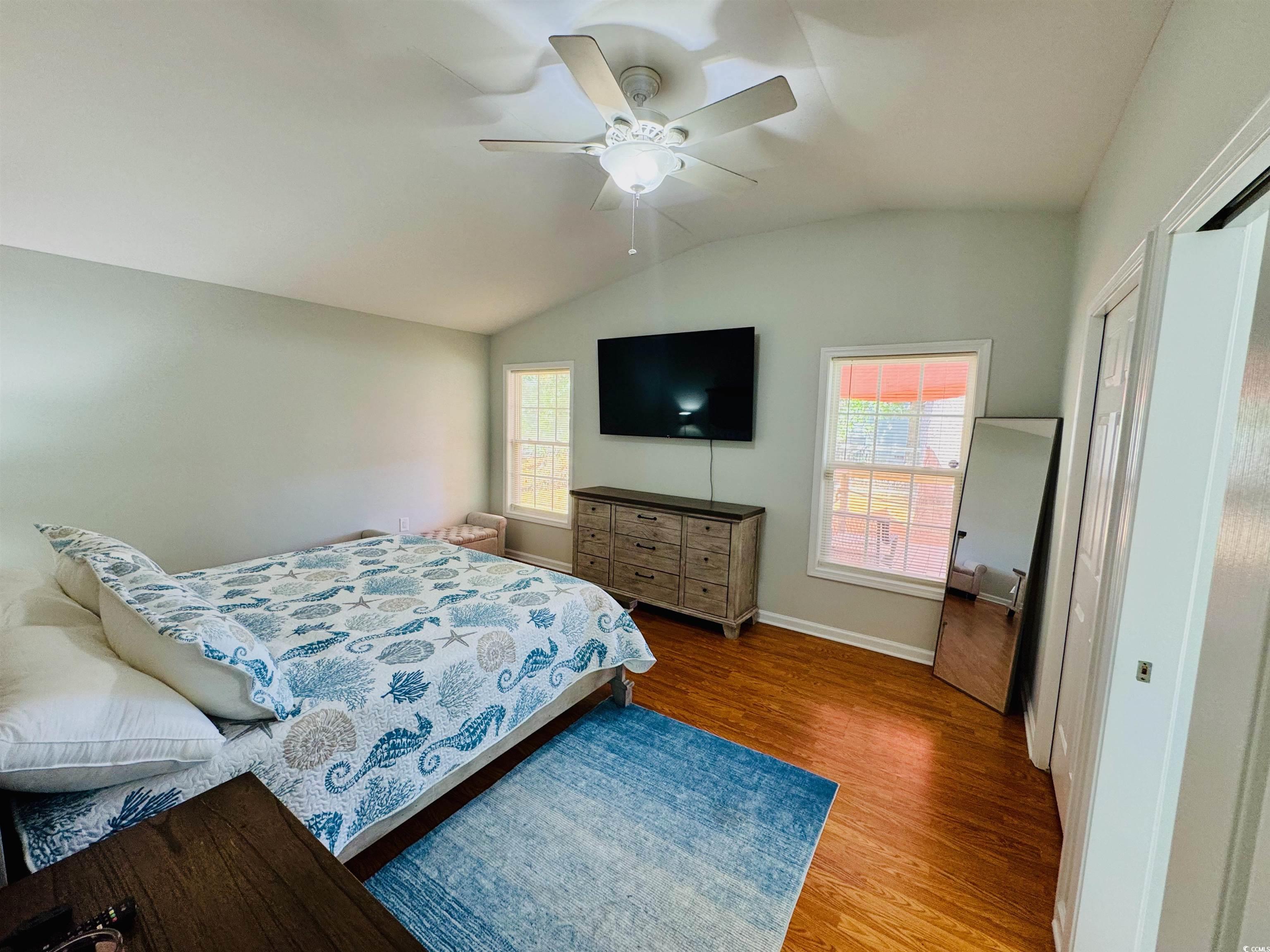 1960 Lake View Circle Surfside Beach, SC 29575 - Photo 20 of 40 Bedroom featuring vaulted ceiling, wood finished floors, and a ceiling fan