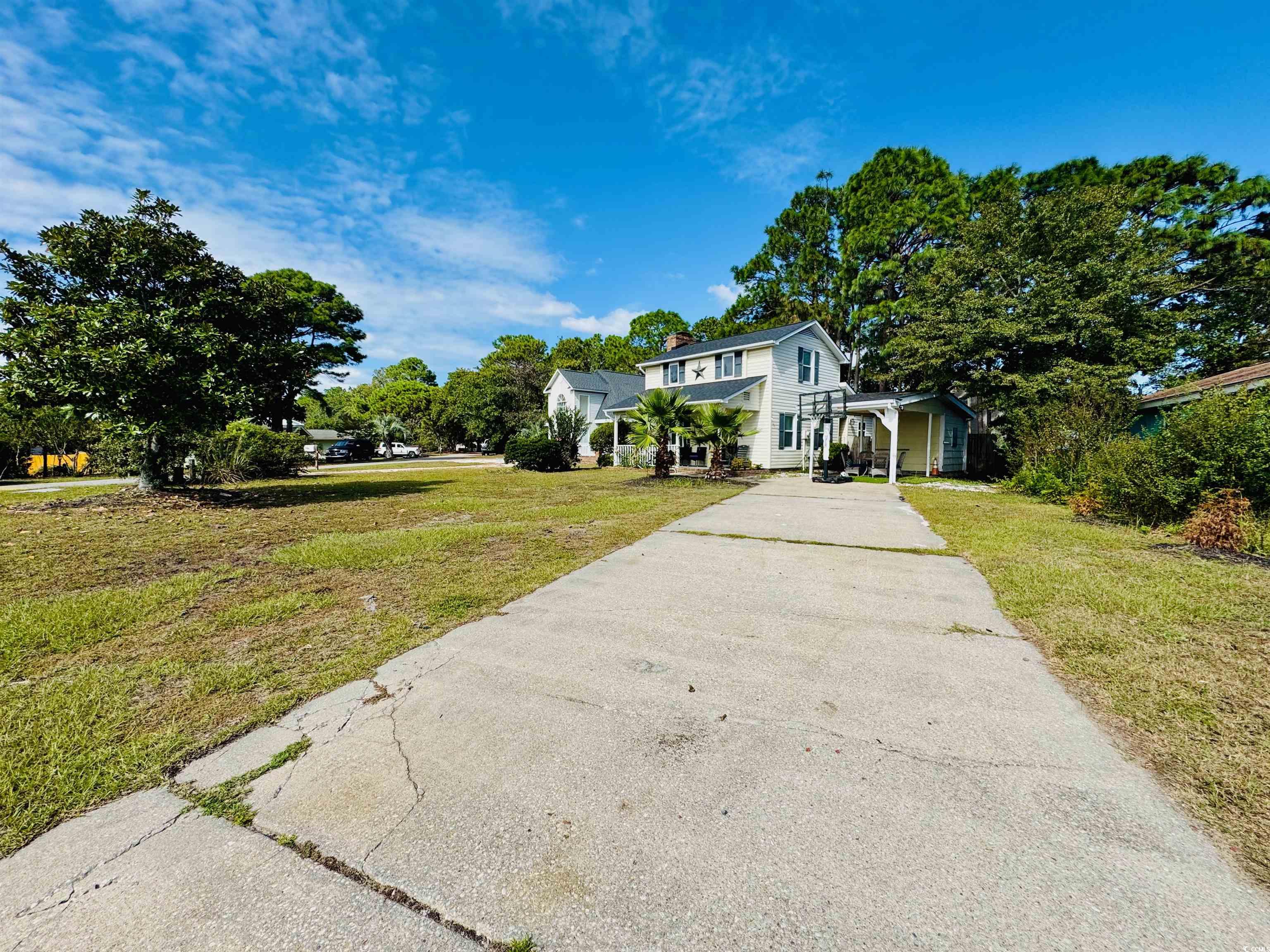 1960 Lake View Circle Surfside Beach, SC 29575 - Photo 2 of 40 Traditional home featuring a front lawn and concrete driveway