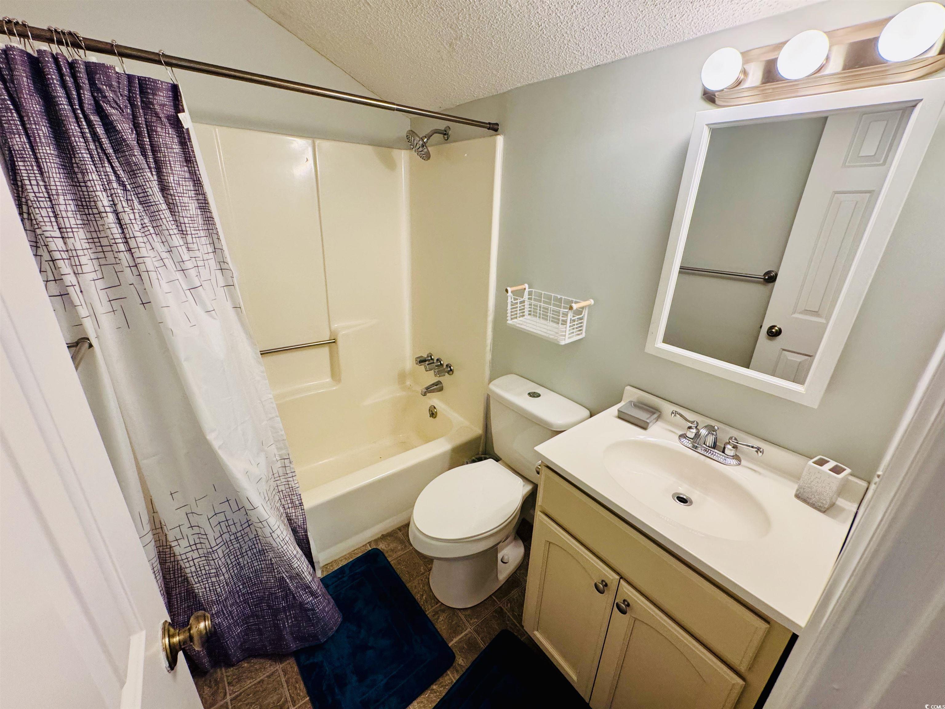 1960 Lake View Circle Surfside Beach, SC 29575 - Photo 30 of 40 Full bathroom featuring a textured ceiling, shower / bath combo with shower curtain, and vanity