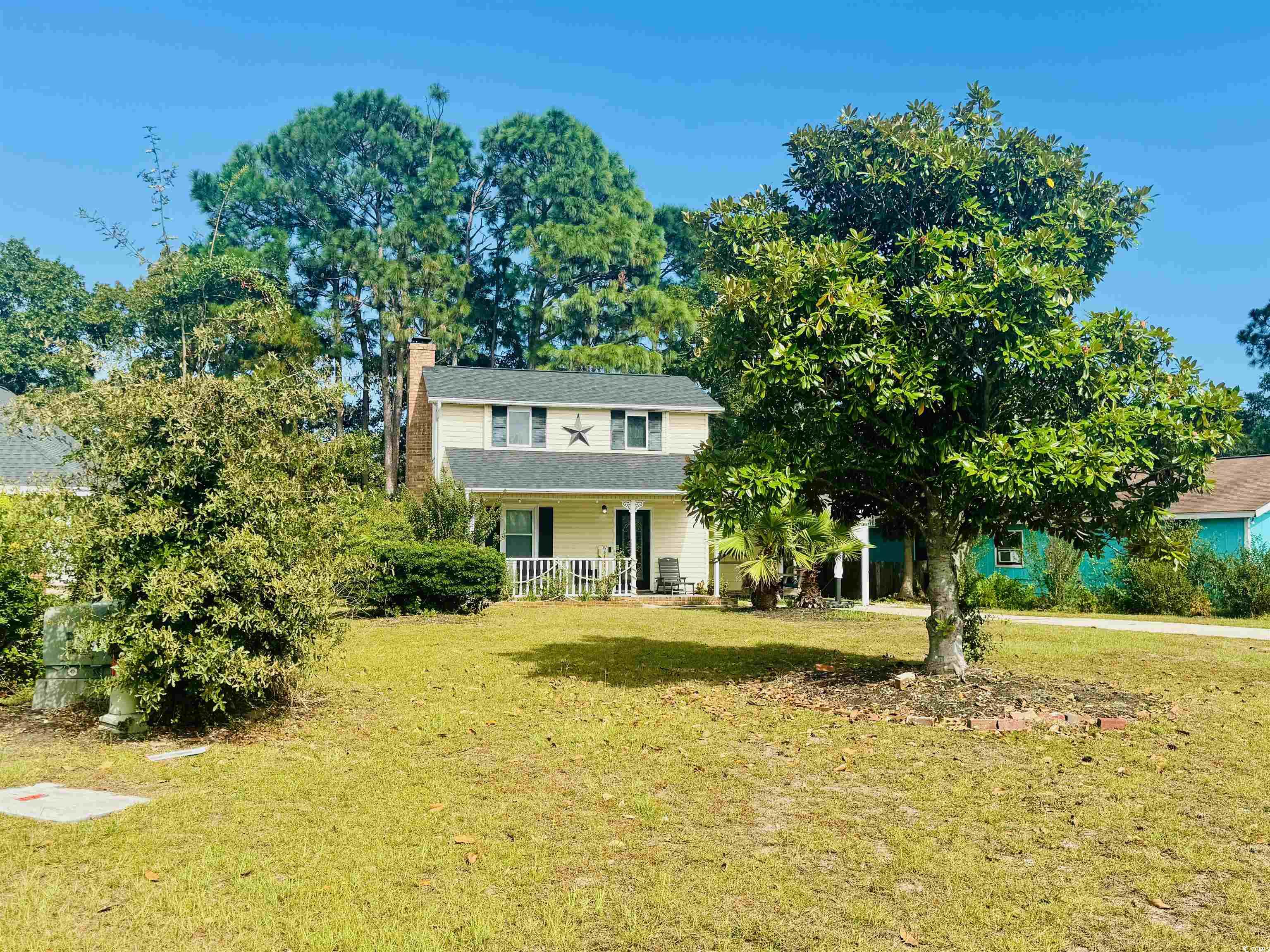 1960 Lake View Circle Surfside Beach, SC 29575 - Photo 3 of 40 View of front of home with a porch, a front lawn, and a chimney