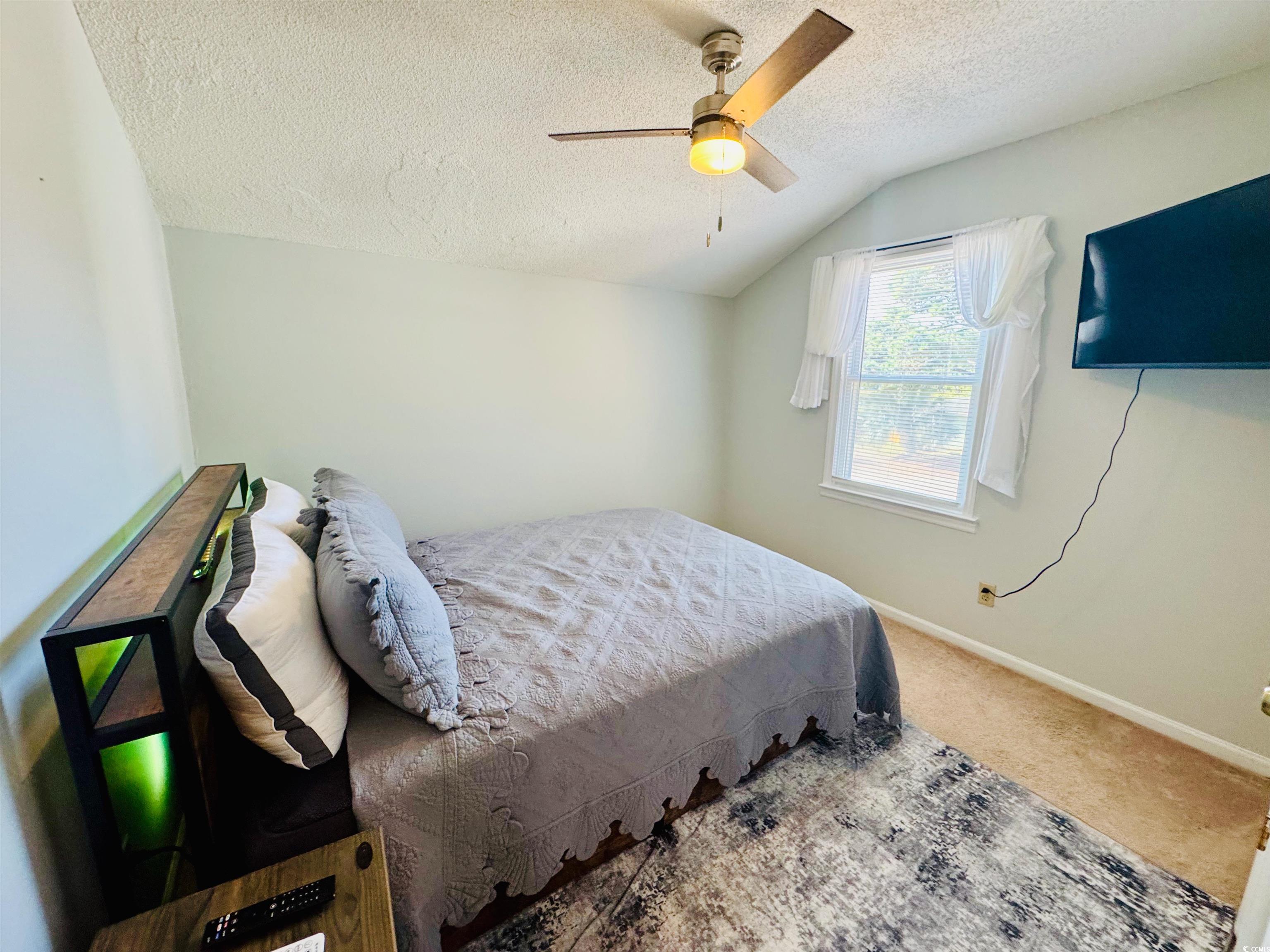 1960 Lake View Circle Surfside Beach, SC 29575 - Photo 31 of 40 Bedroom with carpet, lofted ceiling, a textured ceiling, and ceiling fan