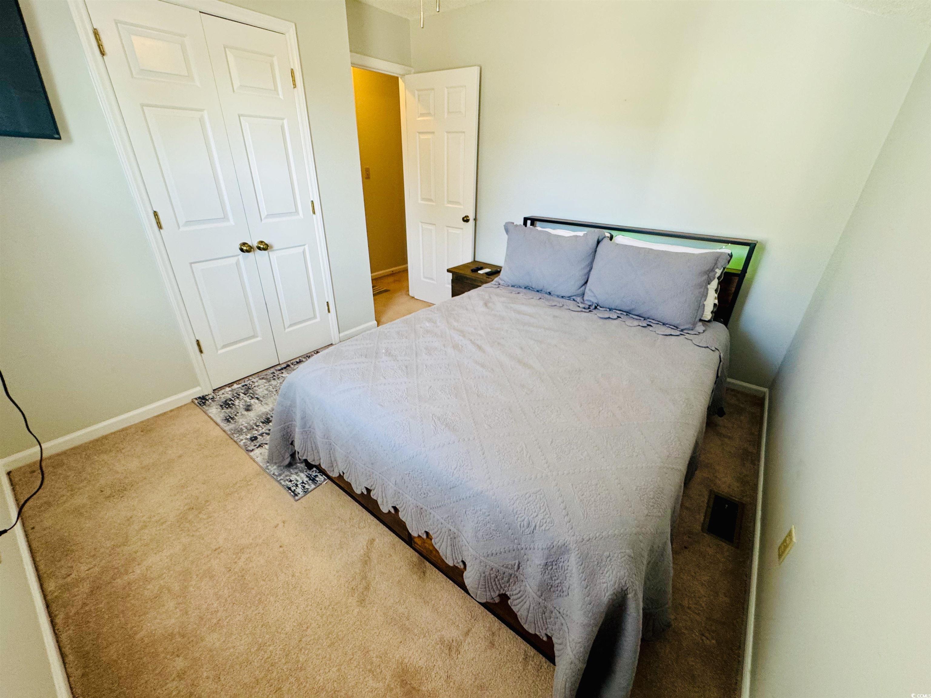 1960 Lake View Circle Surfside Beach, SC 29575 - Photo 32 of 40 Bedroom featuring light colored carpet and a closet