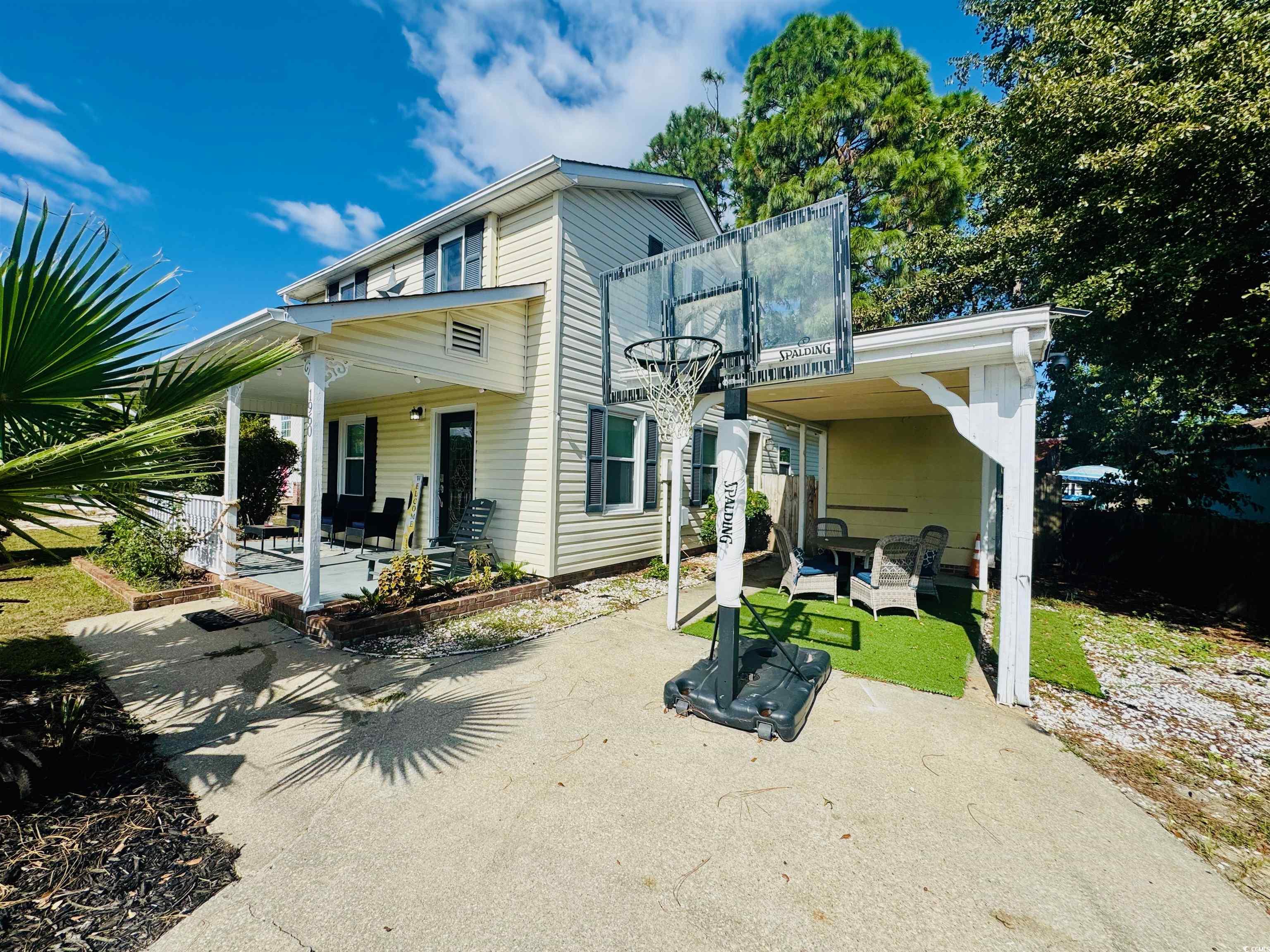 1960 Lake View Circle Surfside Beach, SC 29575 - Photo 4 of 40 Back of house with a patio area and a lawn