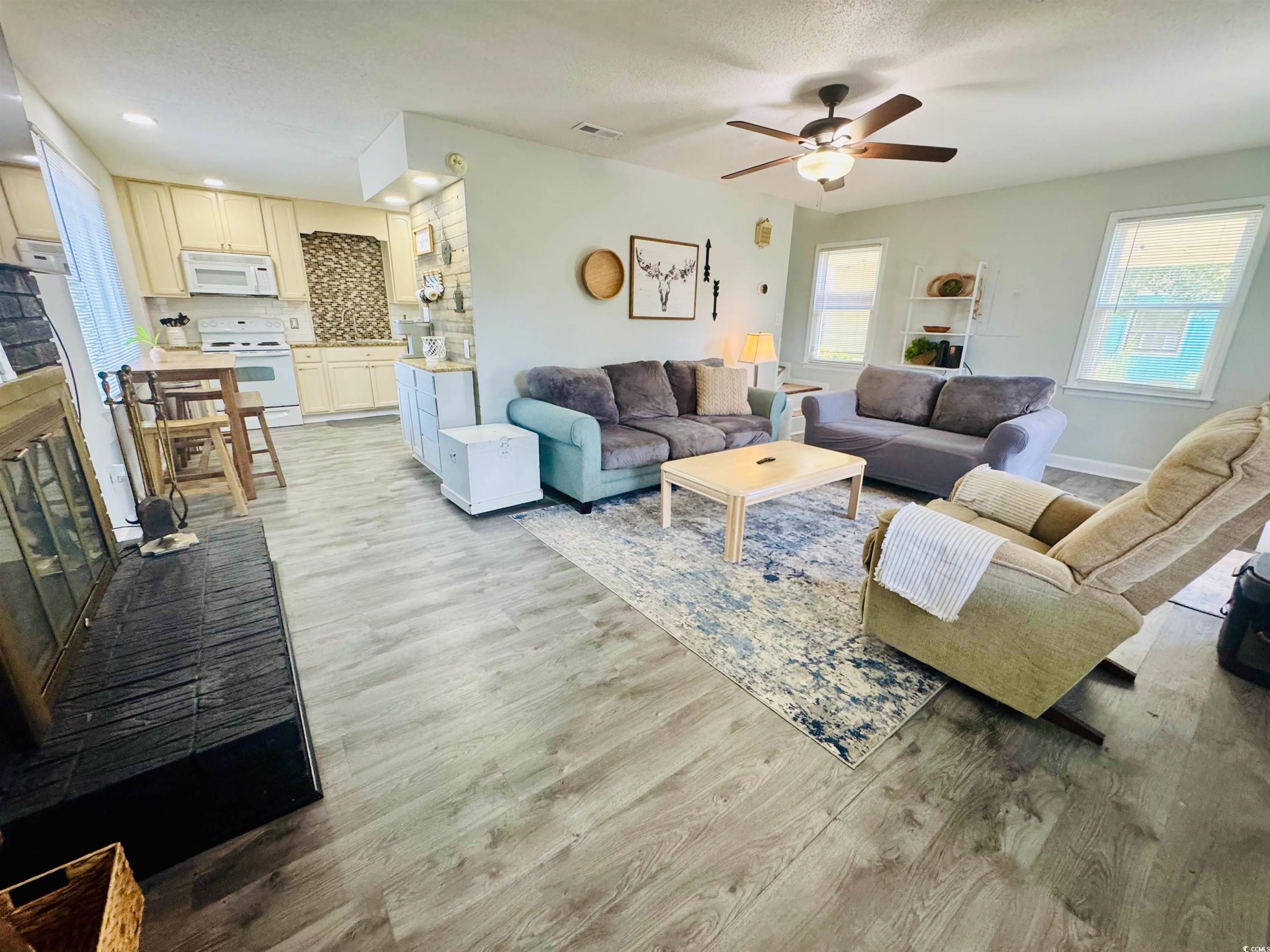 1960 Lake View Circle Surfside Beach, SC 29575 - Photo 10 of 40 Living room with healthy amount of natural light, light wood-style floors, and ceiling fan