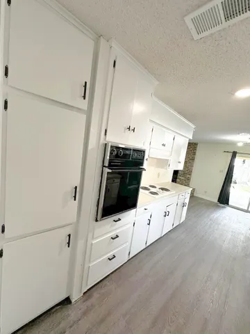 a kitchen with stainless steel appliances a stove a microwave and a white refrigerator