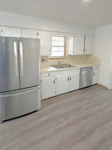 a white refrigerator freezer sitting in a kitchen