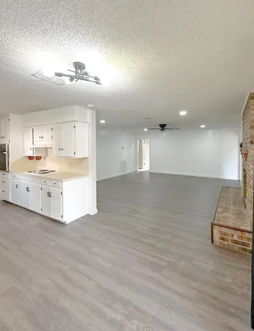 a large room with kitchen view and a sink