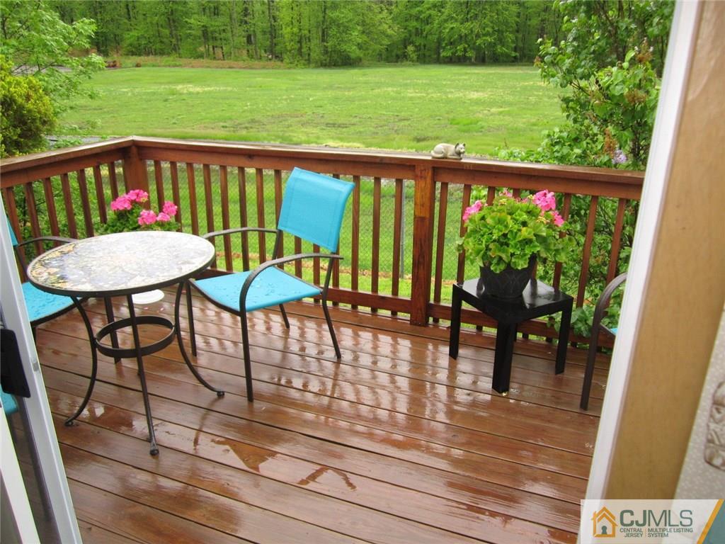 36 Whitman Road, Unit 1 North Brunswick, NJ 08902 - Photo 11 of 18 a view of a chairs and table on the wooden deck