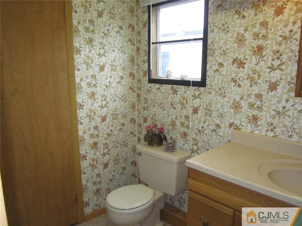 36 Whitman Road, Unit 1 North Brunswick, NJ 08902 - Photo 15 of 18 a white toilet sitting next to a shower curtain
