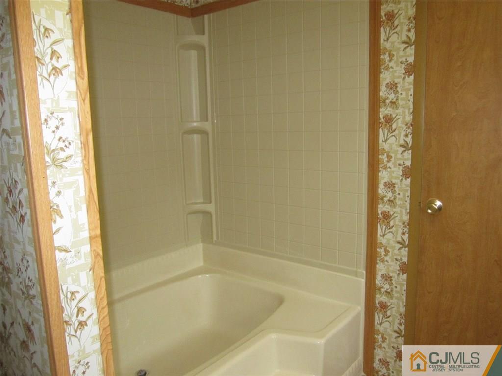 36 Whitman Road, Unit 1 North Brunswick, NJ 08902 - Photo 16 of 18 a bathroom with a tub and shower