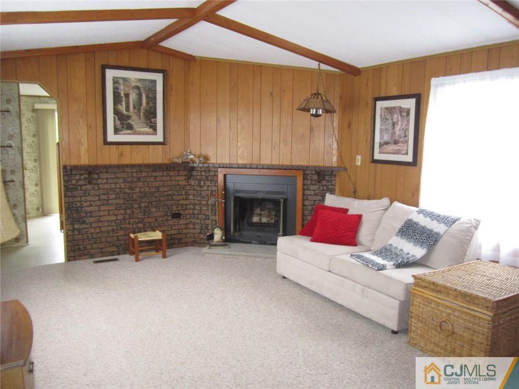 36 Whitman Road, Unit 1 North Brunswick, NJ 08902 - Photo 4 of 18 a living room with furniture and a fireplace
