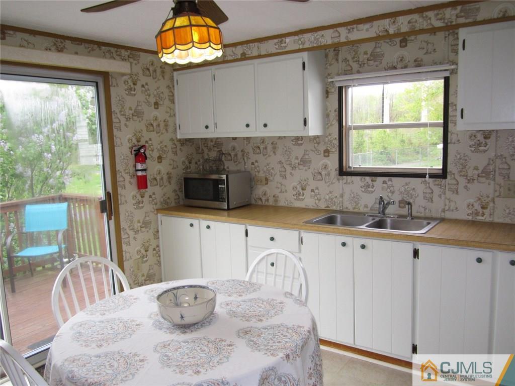 36 Whitman Road, Unit 1 North Brunswick, NJ 08902 - Photo 6 of 18 a kitchen with stainless steel appliances granite countertop a sink window and cabinets